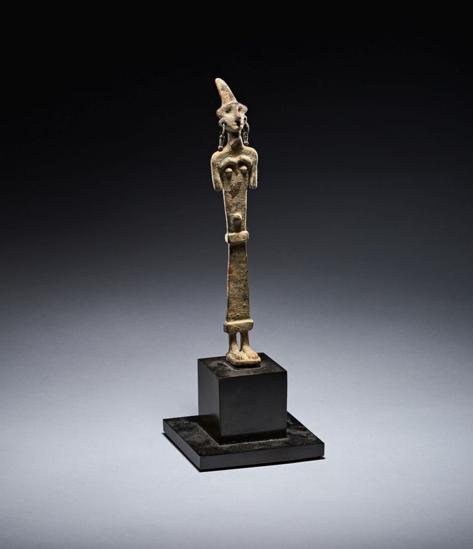 A RARE CANNANITE BRONZE ELONGATED STANDING FEMALE DEITY FIGURE WITH SILVER EARRINGS. CIRCA: 1200 B.C (1 of 6)