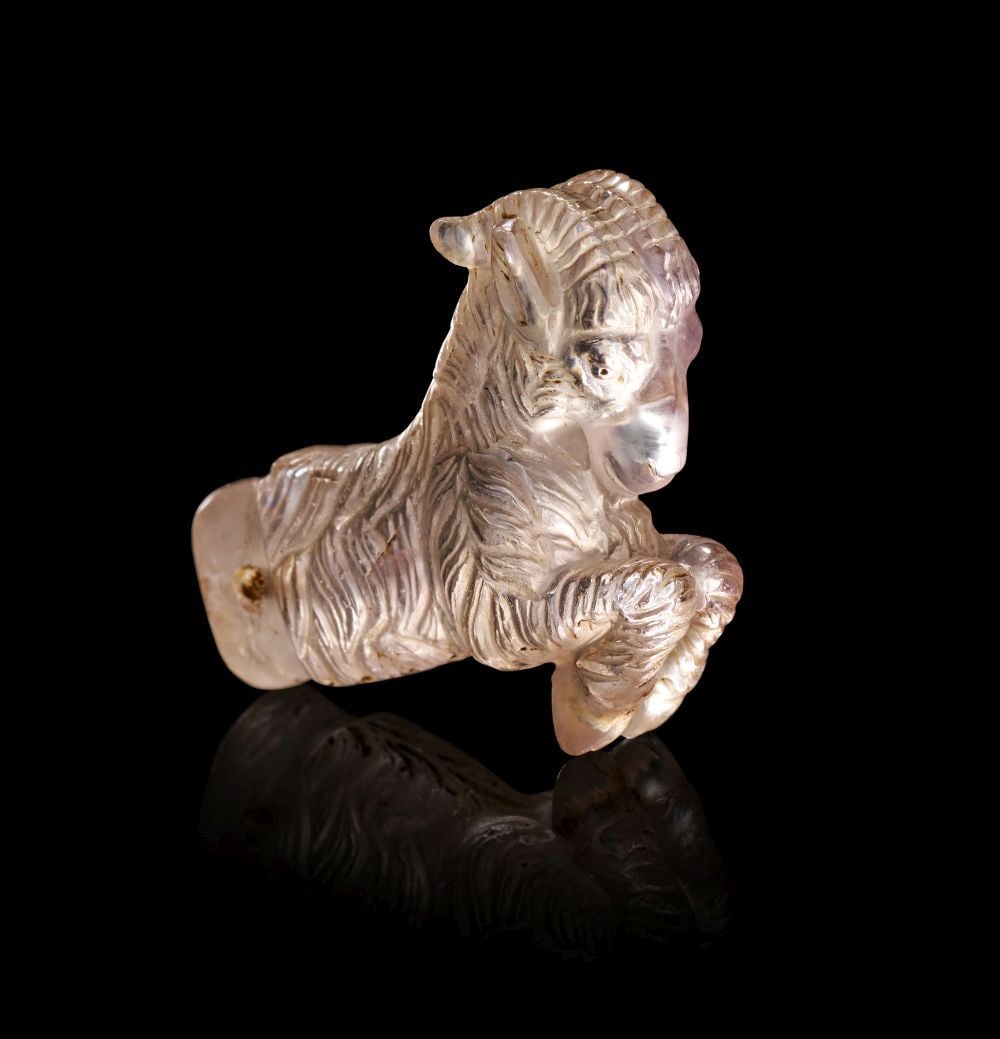 AN ACHAEMENID ROCK CRYSTAL GALLOPING RAM AMULET CIRCA 5TH–4TH CENTURY B.C.: AN ACHAEMENID ROCK CRYSTAL GALLOPING RAM AMULET CIRCA 5TH–4TH CENTURY B.C. Carved in translucent rock crystal with faint internal inclusions, the amulet is modelled in the form of a ram in dynam
