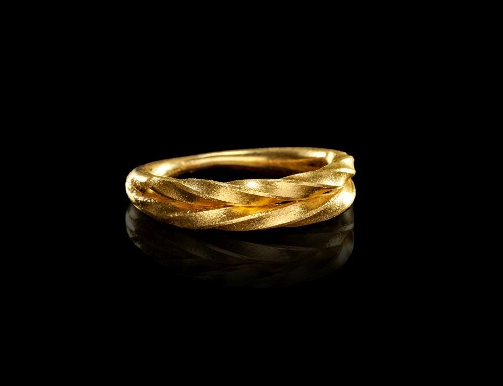 A VIKING TWISTED GOLD RING, CIRCA 9TH-10TH CENTURY A.D.: A VIKING TWISTED GOLD RING, CIRCA 9TH-10TH CENTURY A.D. This Viking gold ring is formed as a circular band with a strongly modelled twisted design, giving the surface a rhythmic, rope-like movement. T