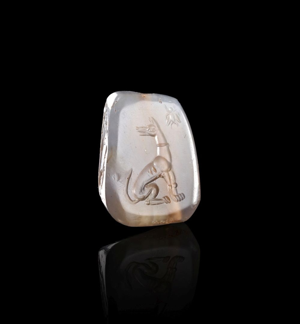 A GRECO-PERSIAN CHALCEDONY PYRAMIDAL STAMP SEAL WITH A HOUND & ANIMALS, ARCHAIC WESTERN COURT STYLE,: A GRECO-PERSIAN CHALCEDONY PYRAMIDAL STAMP SEAL WITH A HOUND & ANIMALS, ARCHAIC WESTERN COURT STYLE, A Greco-Persian chalcedony pyramidal stamp seal, carved in a pale translucent stone with warm i