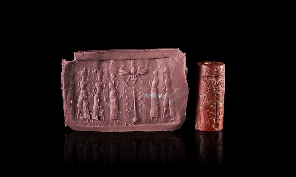 A FINE NEO-ASSYRIAN RED JASPER CYLINDER SEAL CIRCA 750-650 B.C. (1 of 3)