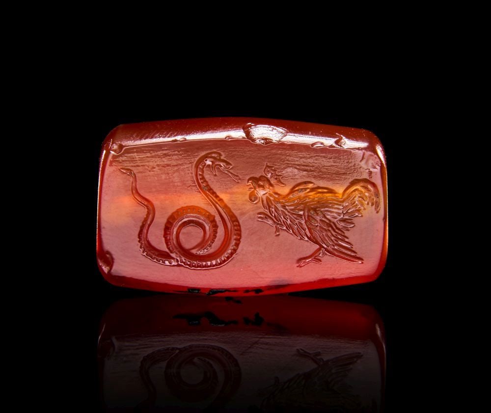 A GREEK CARNELIAN SCARAB WITH A SERPENT & HEN, ARCHAIC PERIOD, CIRCA EARLY 5TH CENTURY B.C: A GREEK CARNELIAN SCARAB WITH A SERPENT & HEN, ARCHAIC PERIOD, CIRCA EARLY 5TH CENTURY B.C Finel