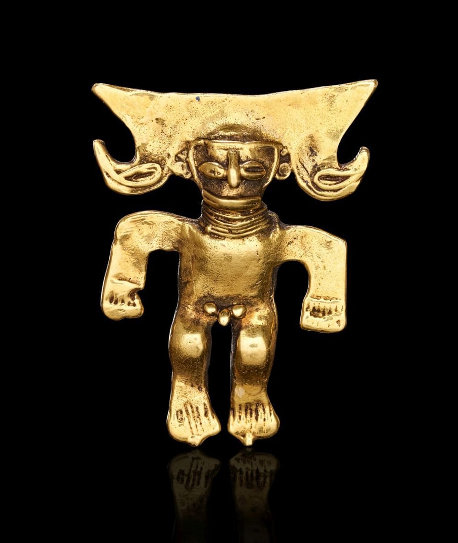 A SOLID GOLD PRE-COLUMBIAN FIGURE OF A DEITY, CIRCA 800–1200 A.D.: A SOLID GOLD PRE-COLUMBIAN FIGURE OF A DEITY, CIRCA 800–1200 A.D. Cast in solid gold, this comp
