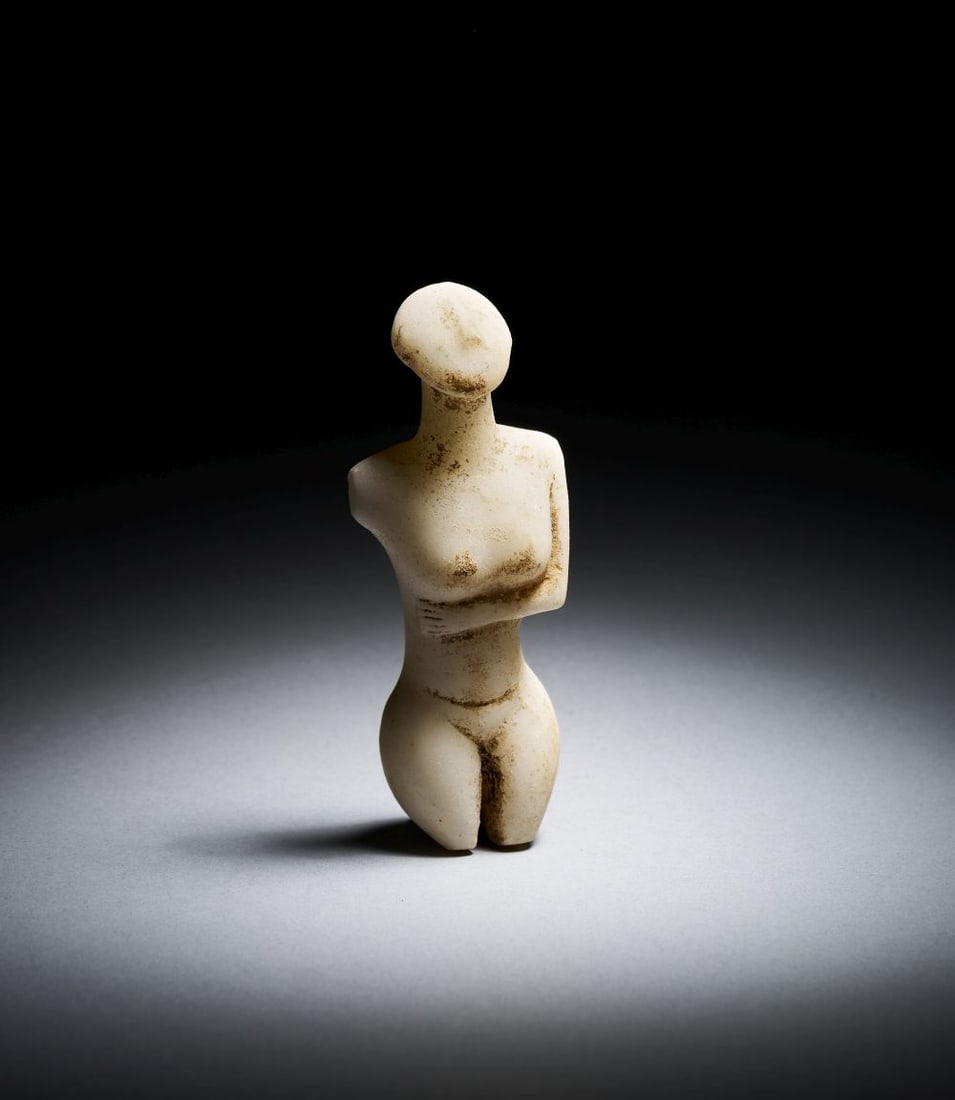 A FRAGMENTARY CYCLADIC MARBLE FEMALE FIGURE EARLY SPEDOS VARIETY, EARLY CYCLADIC II, CIRCA 260: A FRAGMENTARY CYCLADIC MARBLE FEMALE FIGURE EARLY SPEDOS VARIETY, EARLY CYCLADIC II, CIRCA 260 A fragmentary Cycladic marble female figure of Early Spedos variety, Early Cycladic II, circa 2600-2500 B
