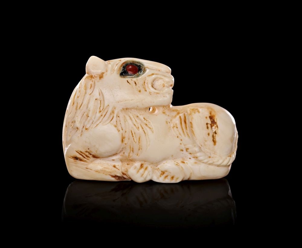 A MESOPOTAMIAN WHITE STONE SEAL WITH A RED GEM INLAY, JEMDET NASR PERIOD, CIRCA 3300-2900 B.C. (1 of 3)