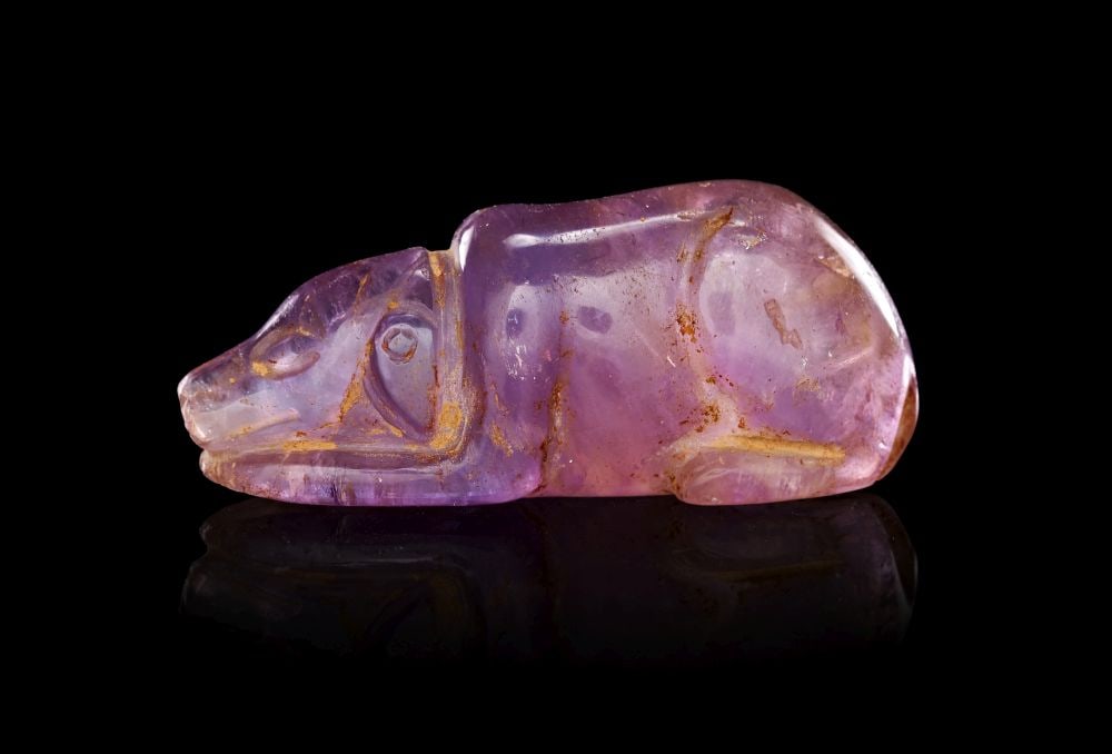 AN ELAMITE AMETHYST AMULET OF A SEATED ANIMAL, CIRCA: 1ST MILLENNIUM B.C. (1 of 3)