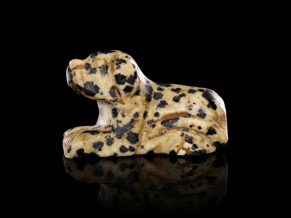 A ROMANO-EGYPTIAN MOTTLED STONE OF A SEATED DOG. CIRCA: 1ST CENTURY B.C- A.D. (1 of 3)