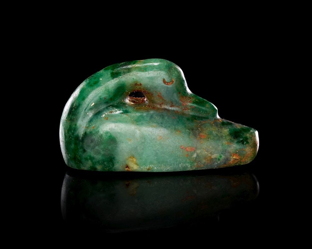 AN ASSYRIAN GREEN CHALCEDONY DUCK WEIGHT, CIRCA: 8TH-6TH CENTURY B.C.: AN ASSYRIAN GREEN CHALCEDONY DUCK WEIGHT, CIRCA: 8TH-6TH CENTURY B.C. An Assyrian green chalcedony duck weight, circa 8th-6th Century B.C. Carved in the form of a recumbent duck with the head turned b