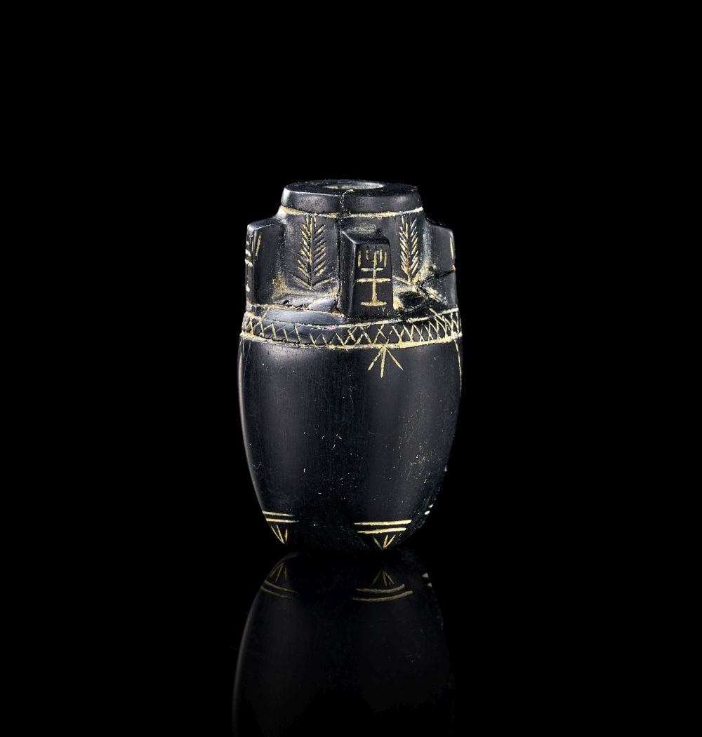 A MINIATURE GARNET AMPHORA DECORATED WITH MENORAH, BYZANTINE, CIRCA 7TH CENTURY A.D. (1 of 3)