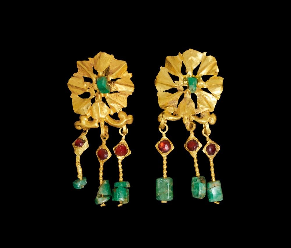A PAIR OF ROMAN GOLD OPENWORK EARRINGS WITH EMERALD & GARNET, EASTERN MEDITERRANEAN LATE 1ST CENTURY: A PAIR OF ROMAN GOLD OPENWORK EARRINGS WITH EMERALD & GARNET, EASTERN MEDITERRANEAN LATE 1ST CENTURY Formed in high-karat gold, this pair of earrings is composed as openwork repoussé rosett