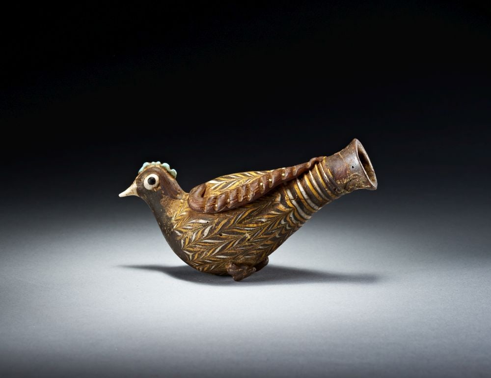 AN EASTERN MEDITERRANEAN MOSAIC GLASS BIRD BEAD CIRCA 1ST CENTURY B.C.-1ST CENTURY A.D.: AN EASTERN MEDITERRANEAN MOSAIC GLASS BIRD BEAD CIRCA 1ST CENTURY B.C.-1ST CENTURY A.D. Worked in richly coloured mosaic glass, the bead is formed as a stylised bird with rounded body, tapering tail a