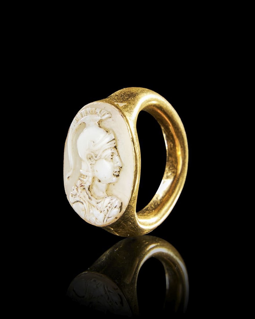 A GOLD ROMAN CAMEO RING OF MINERVA Circa 1st Century B.C.–1st Century A.D.: A GOLD ROMAN CAMEO RING OF MINERVA Circa 1st Century B.C.–1st Century A.D. A solid gold r
