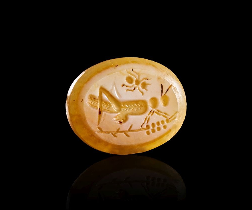A ROMAN AGATE INTAGLIO ENGRAVED GRASSHOPPER ON PLANTS WITH AN ANT, CIRCA: 1ST CENTURY B.C. (1 of 1)