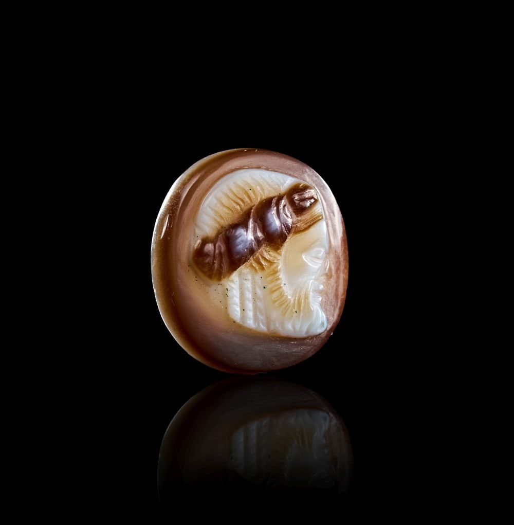 A ROMAN SARDONYX CAMEO OF A SILENUS, CIRCA: 1ST CENTURY B.C.: A ROMAN SARDONYX CAMEO OF A SILENUS, CIRCA: 1ST CENTURY B.C. A Roman sardonyx cameo carved with the profile head of Silenus. The layered stone has been skilfully used to create contrast between the pa