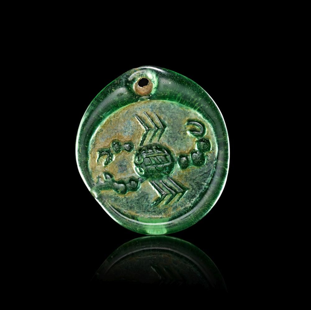 A LATE ROMAN OR EARLY BYZANTINE GLASS PENDANT OF A SCORPIAN CIRCA 4TH-5TH CENTURY A.D. (1 of 2)