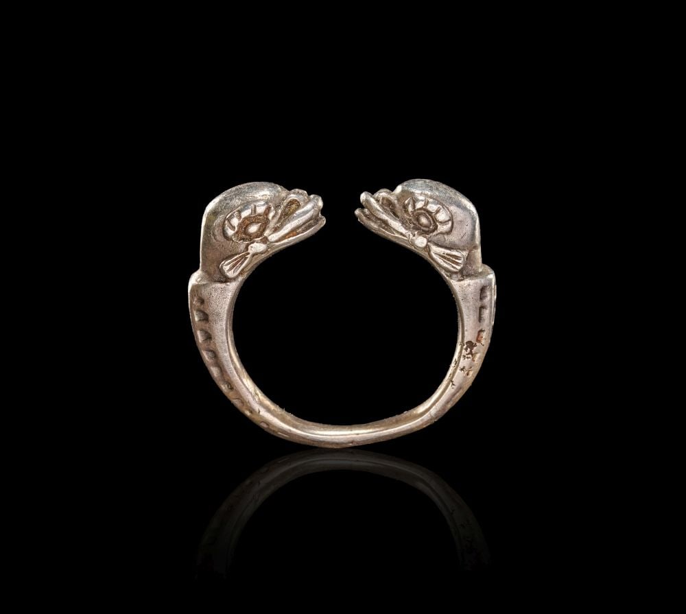 A ROMAN SILVER DOLPHIN RING CIRCA 2ND CENTURY A.D.: A ROMAN SILVER DOLPHIN RING CIRCA 2ND CENTURY A.D. A Roman silver ring, circa 2nd century A.D., formed as an open hoop with the terminals modelled as opposed dolphins. The ring has a compact, sculptur