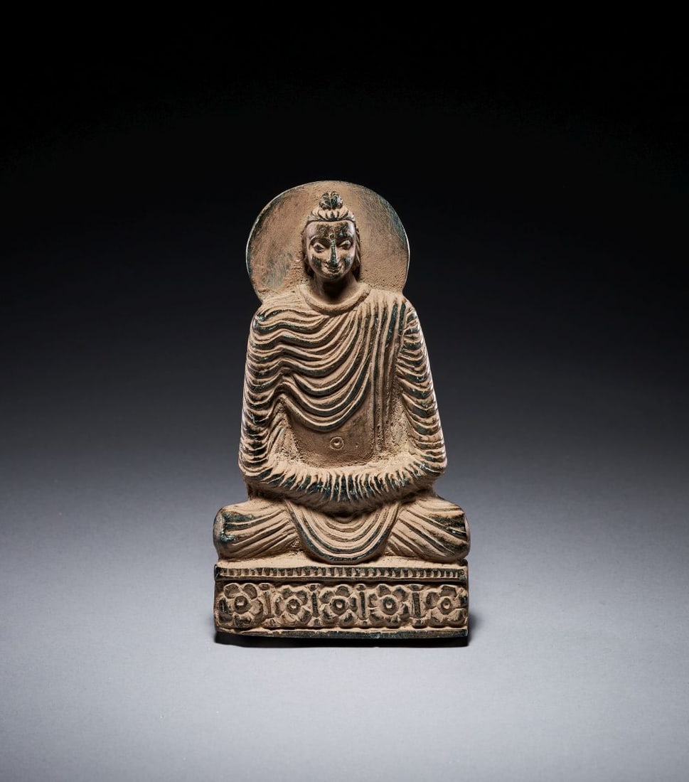 A CARVED GREY SCHIST FIGURE OF A SEATED BUDDA, ANCIENT REGION OF GANDHARA 2ND-3RD CENTURY: A CARVED GREY SCHIST FIGURE OF A SEATED BUDDA, ANCIENT REGION OF GANDHARA 2ND-3RD CENTURY A carved grey schist figure of a seated Buddha, from the ancient region of Gandhara, dating to the 2nd–3