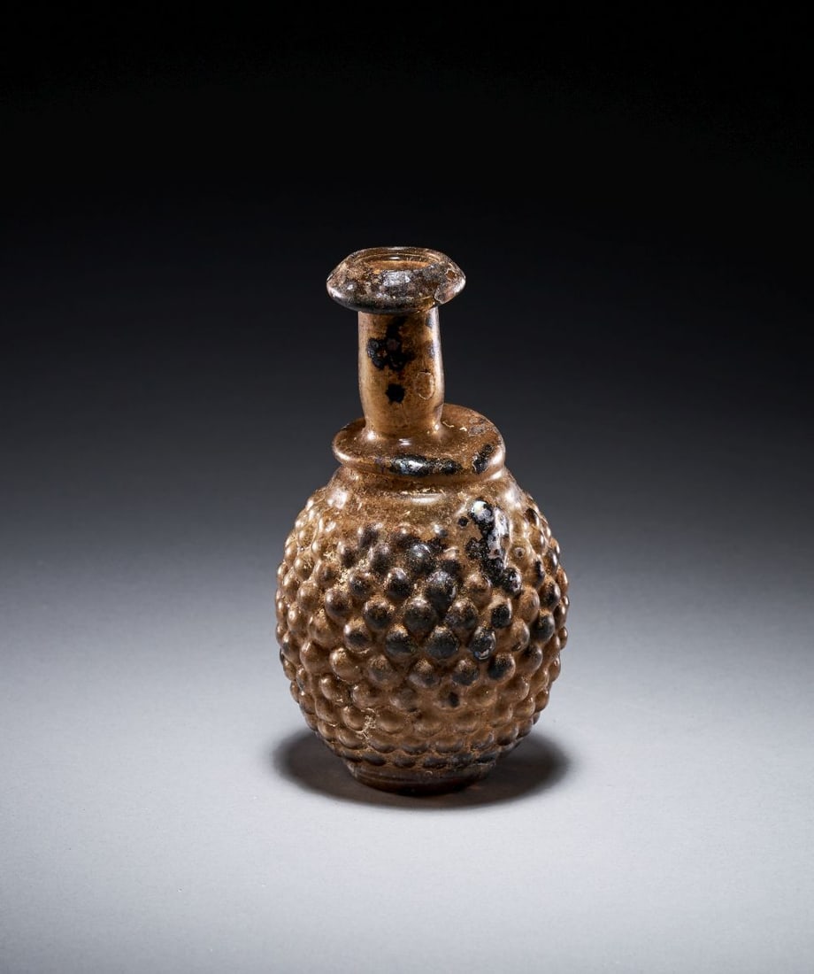A ROMAN GLASS GRAPE FLASK CIRCA 3RD CENTURY A.D. (1 of 4)