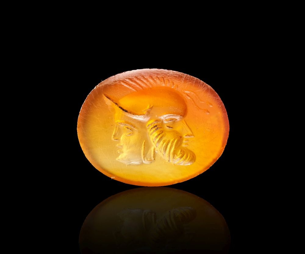 A ROMAN CARNELIAN INTAGLIO COMPOSED OF HEADS OF SILENUS AND MINERVA, CIRCA: 1ST-2ND CENTURY A.D. (1 of 1)