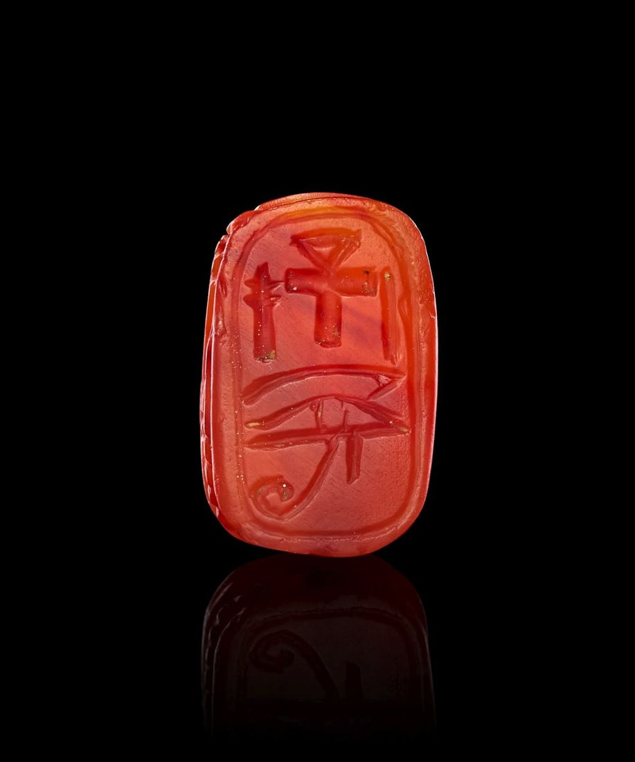 AN EGYPTIAN RED CARNELIAN SCARAB WITH ANKH & EYE OF HORUS DYNASTY XVIII, 1550-1307 B.C. (1 of 3)