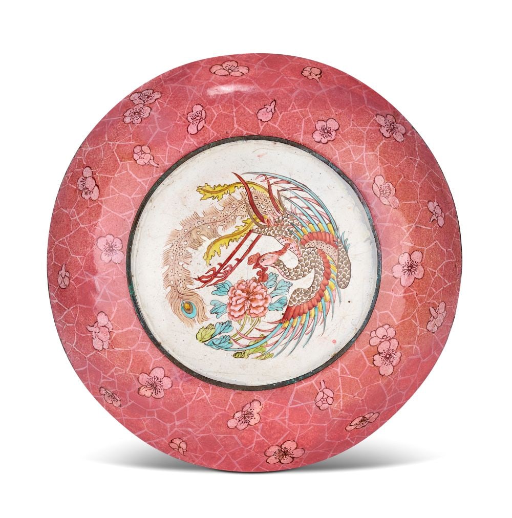 A CHINESE PAINTED ENAMEL DISH, QIANLONG PERIOD (1736-1795): A CHINESE PAINTED ENAMEL DISH, QIANLONG PERIOD (1736-1795) The shallow circular dish is finely worked in painted enamels, its broad, gently curving surface used as a continuous decorative field. The f