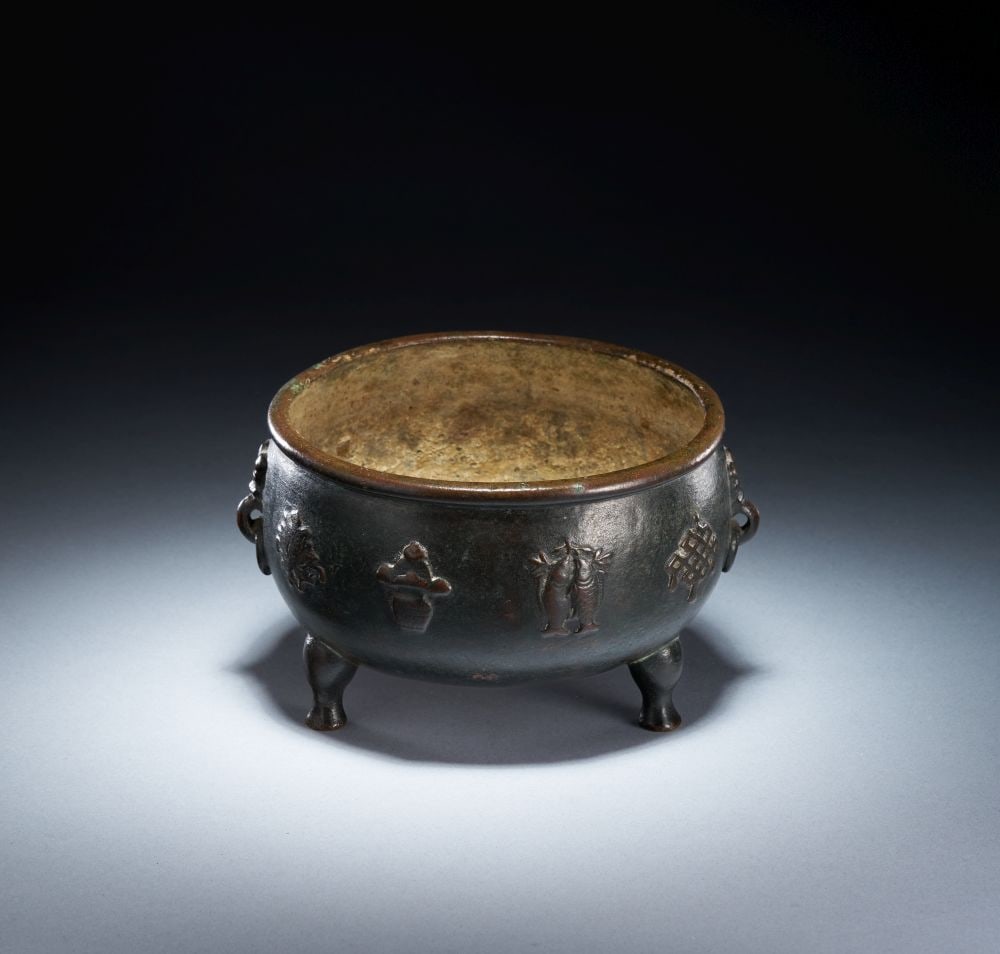 A CHINESE BRONZE "ONE HUNDRED ANTIQUE" INSCRIBED TRIPOD INCENSE BURNER, QING DYNASTY (1644-1911): A CHINESE BRONZE "ONE HUNDRED ANTIQUE" INSCRIBED TRIPOD INCENSE BURNER, QING DYNASTY (1644-1911) A Chinese bronze tripod incense burner of compressed globular form, raised on three short feet and set 