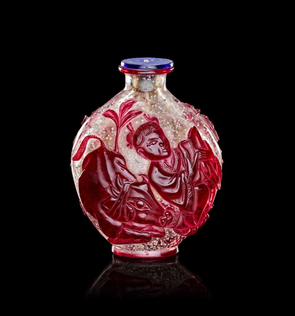 A RUBY-RED OVERLAY SNOWFLAKE GLASS DEPICTING ANIMALS, QING DYNASTY (1644-1911) (1 of 3)