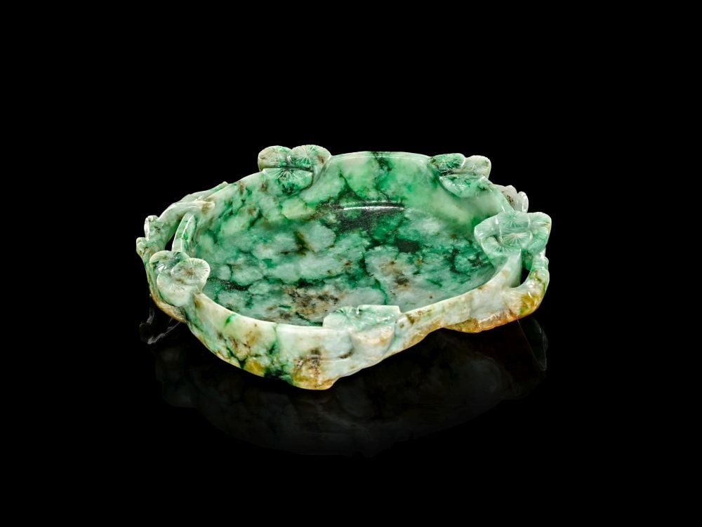 A CHINESE JADEITE "PINE" WASHER BIXI, QING DYNASTY (1644-1911): A CHINESE JADEITE "PINE" WASHER BIXI, QING DYNASTY (1644-1911) Of shallow oval form, this jadeite washer is carved as a small bixi, or scholar’s water vessel, the broad recessed well framed by a