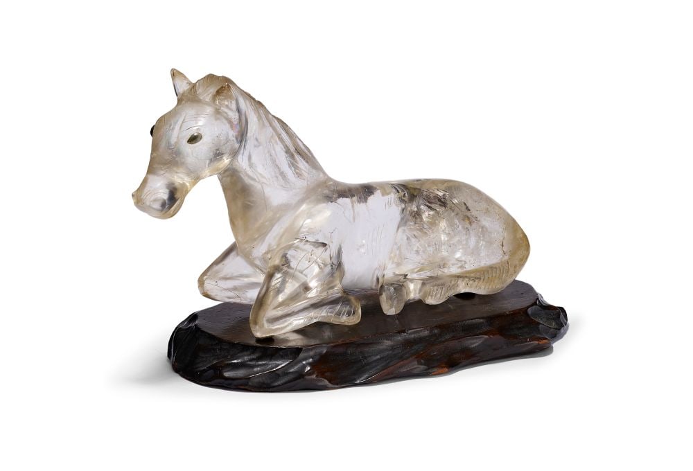 A LARGE ROCK CRYSTAL FIGURINE OF A RECUMBENT HORSE ON A HARDWOOD STAND, QING DYNASTY (1644-1911) (1 of 7)