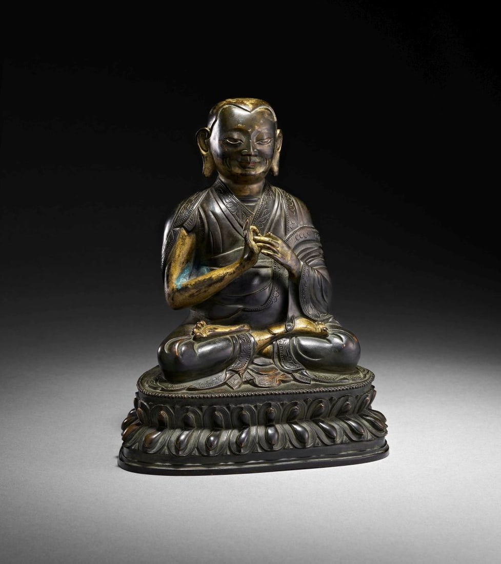 A GILT BRONZE FIGURE OF A LAMA TIBET, CIRCA 15TH CENTURY (1 of 5)