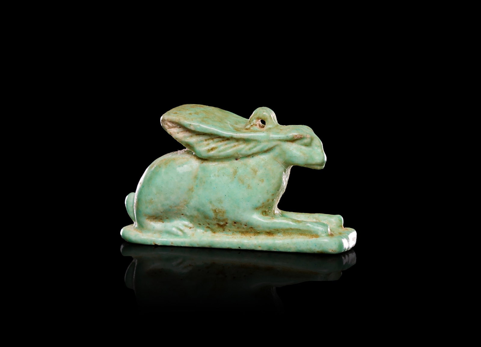 AN EGYPTIAN FAIENCE AMULET OF A HARE, NEW KINGDOM, DYNASTY XVIII, CIRCA 1353-1336 B.C. (1 of 1)