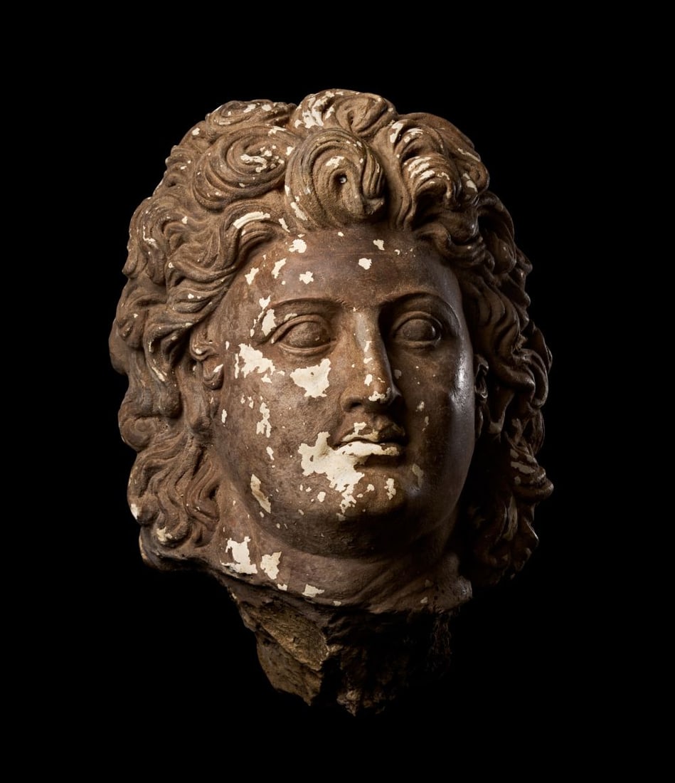 NO RESERVE: AN OVER LIFE SIZED TERRACOTTA HEAD OF ALEXANDER THE GREAT: NO RESERVE: AN OVER LIFE SIZED TERRACOTTA HEAD OF ALEXANDER THE GREAT Modelled in the round and of over life-size scale, the head turned slightly to the proper right and tilted upward, the face broad 