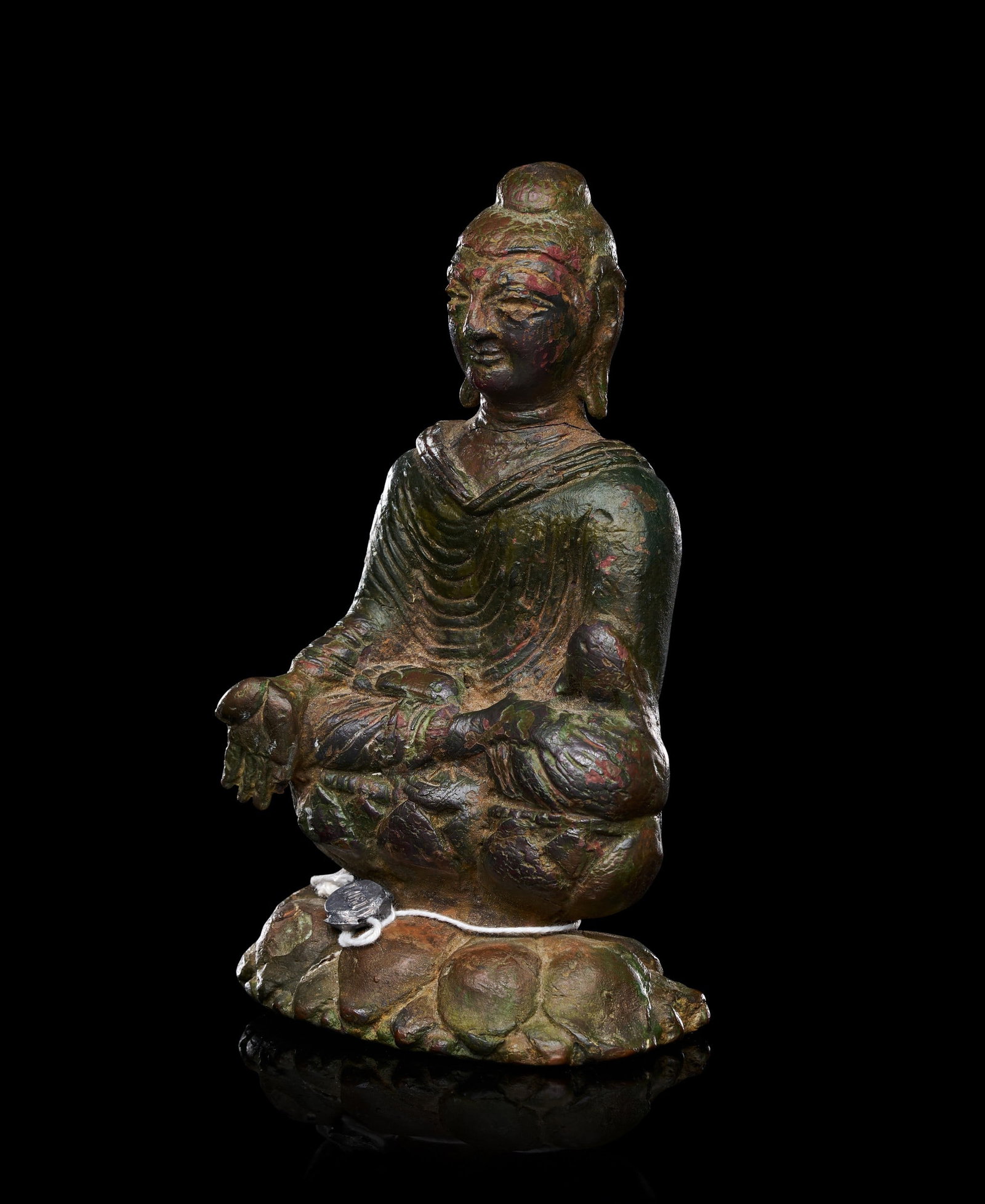 A SILVER-INLAID BRONZE FIGURE OF BUDDHA, SWAT VALLEY, 7TH-8TH CENTURY: A SILVER-INLAID BRONZE FIGURE OF BUDDHA, SWAT VALLEY, 7TH-8TH CENTURYCast seated in dhyanasana on a double-lotus base, the Buddha rendered with broad shoulders and a compact, rounded torso enveloped i