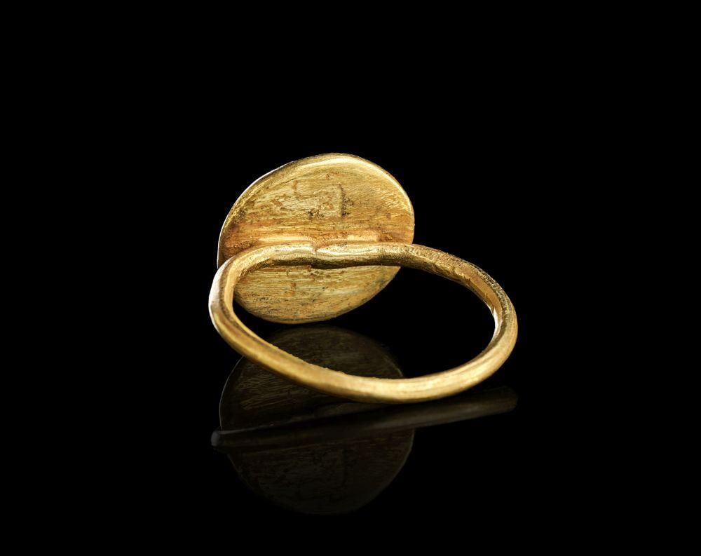 A BYZANTINE HIGH KARAT GOLD MARRIAGE RING, EARLY BYZANTINE CIRCA 6TH-7TH CENTURY A.D.: A BYZANTINE HIGH KARAT GOLD MARRIAGE RING, EARLY BYZANTINE CIRCA 6TH-7TH CENTURY A.D. Solid high-karat gold matrimonial ring with oval bezel engraved in relief with the traditional Christian marriage 