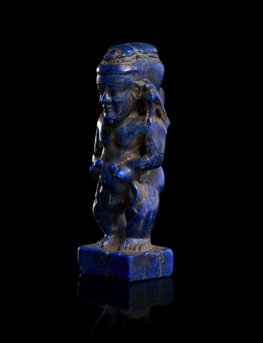 A Highly Rare Egyptian Lapis Lazuli Amulet Depicting Ptaikos, New Kingdom Dynasty XIXâ€“XX (1307â€“1: A Highly Rare Egyptian Lapis Lazuli Amulet Depicting Ptaikos, New Kingdom Dynasty XIXâ€“XX (1307â€“1070 BC) This striking amulet is carved from deep, vivid lapis lazuli and represents Ptaiko