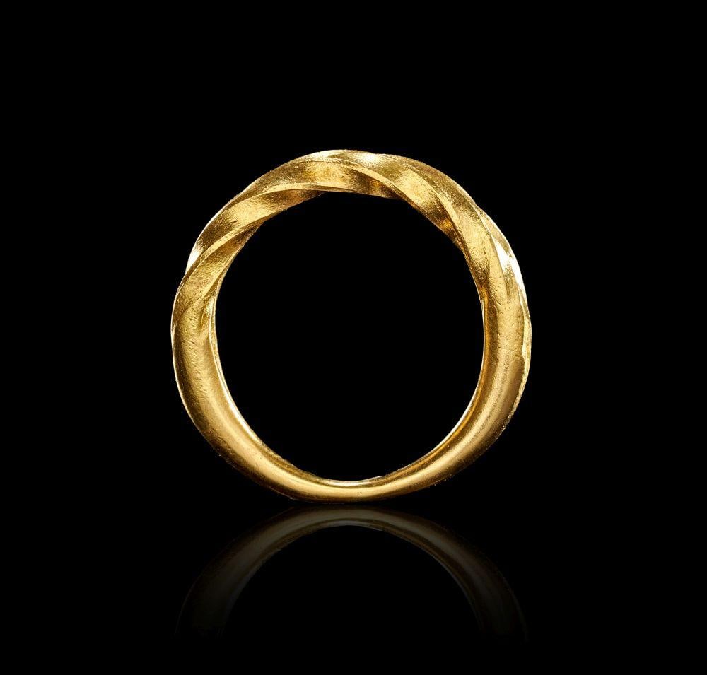 A VIKING TWISTED GOLD RING, CIRCA 9TH-10TH CENTURY A.D.: A VIKING TWISTED GOLD RING, CIRCA 9TH-10TH CENTURY A.D. This Viking gold ring is formed as a circular band with a strongly modelled twisted design, giving the surface a rhythmic, rope-like movement. T