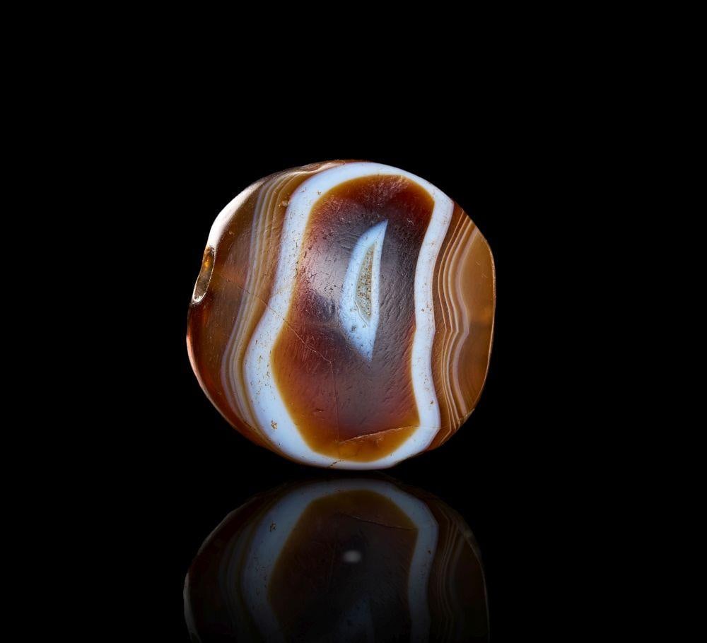 ARCHAIC EASTERN GREEK BANDED AGATE STAMP SEAL CIRCA 6th–5th CENTURY B.C.: ARCHAIC EASTERN GREEK BANDED AGATE STAMP SEAL CIRCA 6th–5th CENTURY B.C. Finely engraved stamp seal in translucent banded agate, depicting two confronted griffins rearing in heraldic symmetry, their