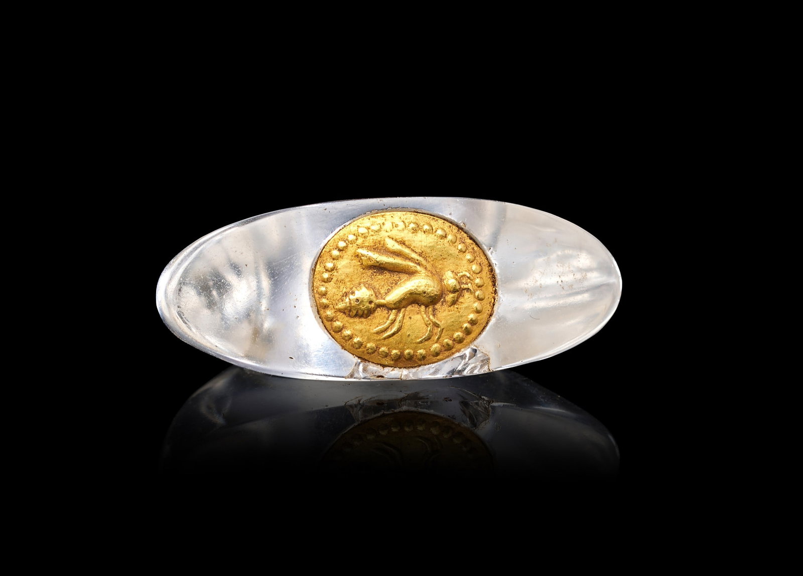 A RARE EGYPTIAN ROCK CRYSTAL & GOLD RING DEPICTING A WASP, NEW KINGDOM, DYNASTY XVIII, AMARNA PERIOD: A RARE EGYPTIAN ROCK CRYSTAL AND GOLD RING DEPICTING A WASP, NEW KINGDOM, DYNASTY XVIII, AMARNA PERIOD Of elongated oval form, the hoop cut from a single piece of transparent rock crystal into a slend