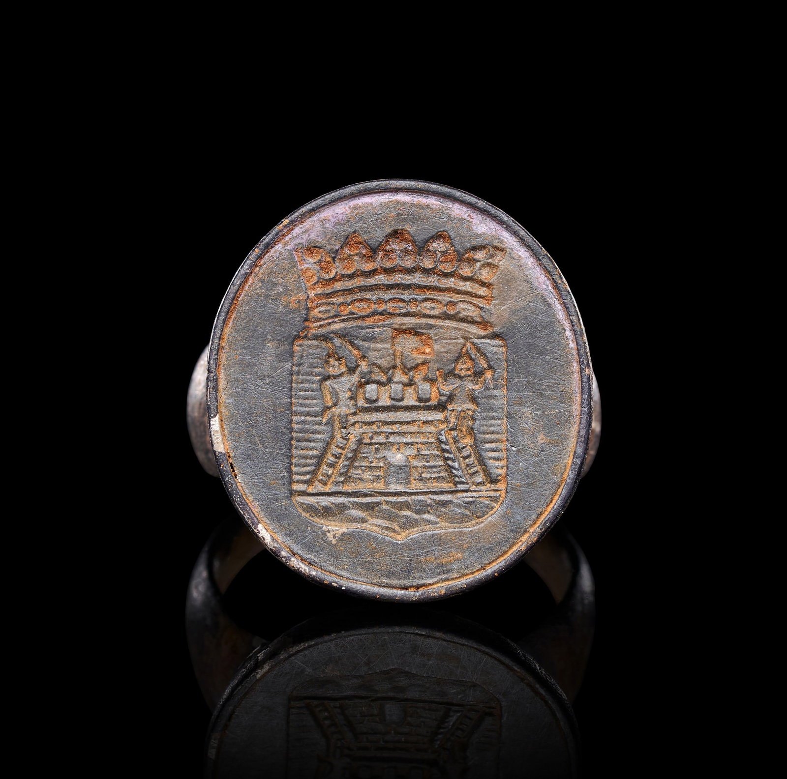 AN UNUSUAL SILVER MEDIEVAL RING WITH COAT OF ARMS, 12TH-13TH CENTURY OR LATER: AN UNUSUAL SILVER MEDIEVAL SEAL RING WITH COAT OF ARMS, 12TH-13TH CENTURY OR LATEROf substantial form, the heavy silver hoop tapering from a broad, rounded shank to support a large oval bezel set tran