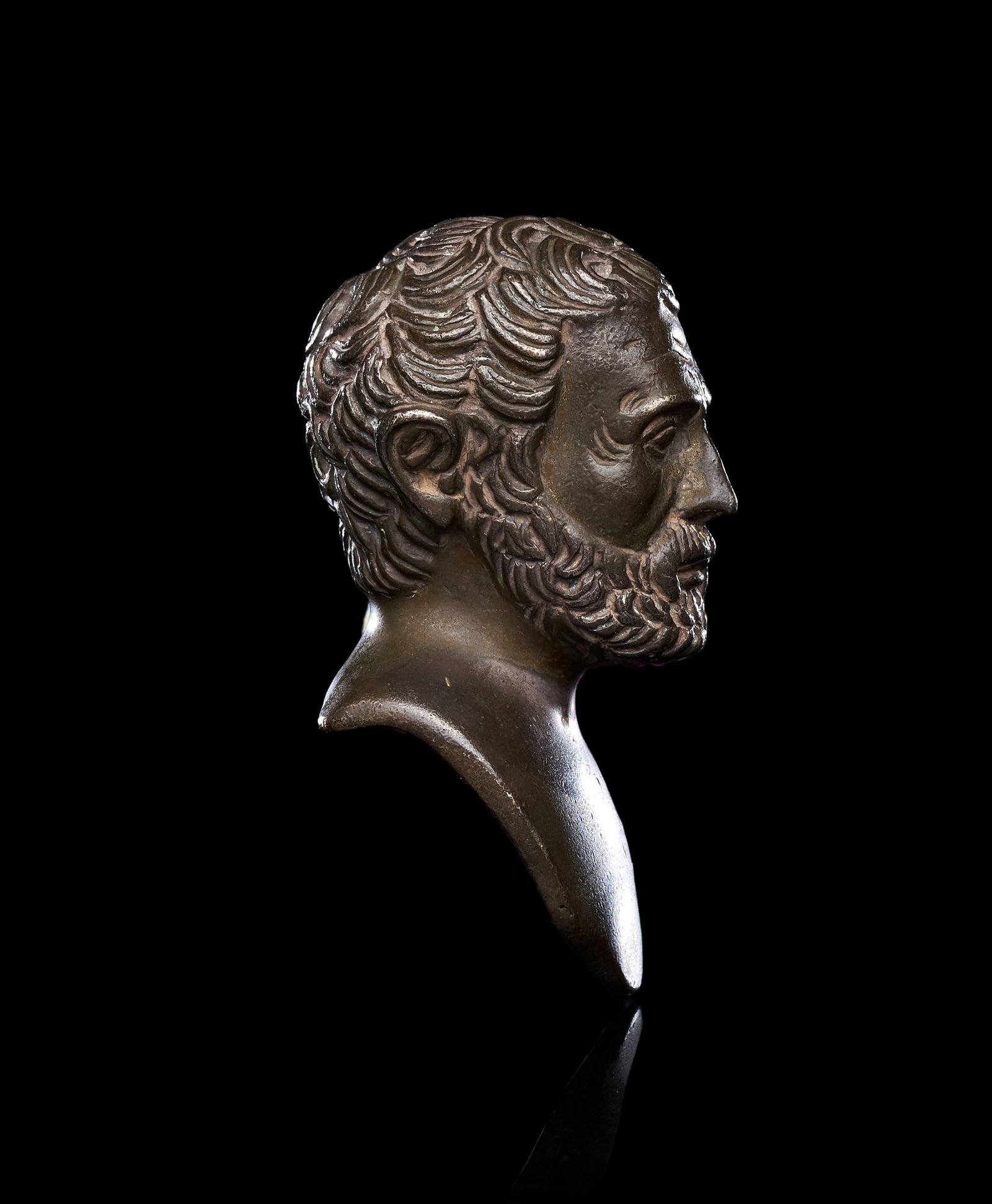 A GRAND TOUR BUST OF A ELDER MAN, 18TH/19TH CENTURY, ITALY: A GRAND TOUR BRONZE BUST OF A BEARDED PHILOSOPHER, ITALY, 18TH/19TH CENTURY Of small cabinet scale, cast in bronze with a dark patina and traces of a warmer coppery tone across the high points. The he