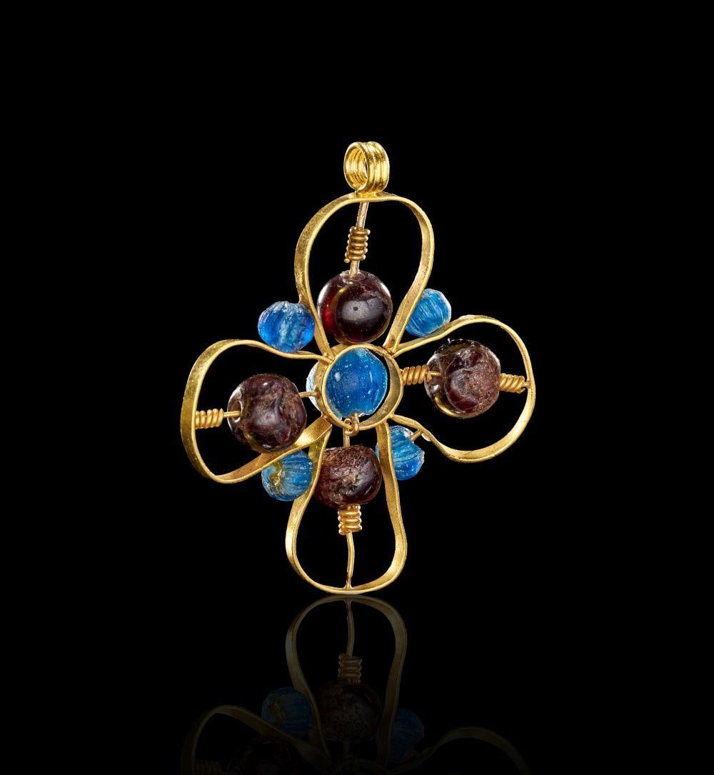 AN UNUSUAL BYZANTINE GOLD & GARNET & AQUAMARINE CROSS, CIRCA 7TH-9TH CENTURY A.D.: AN UNUSUAL BYZANTINE GOLD & GARNET & AQUAMARINE CROSS, CIRCA 7TH-9TH CENTURY A.D. Formed in gold and set with garnet and aquamarine beads, this Byzantine cross pendant has an open, wirework structure 