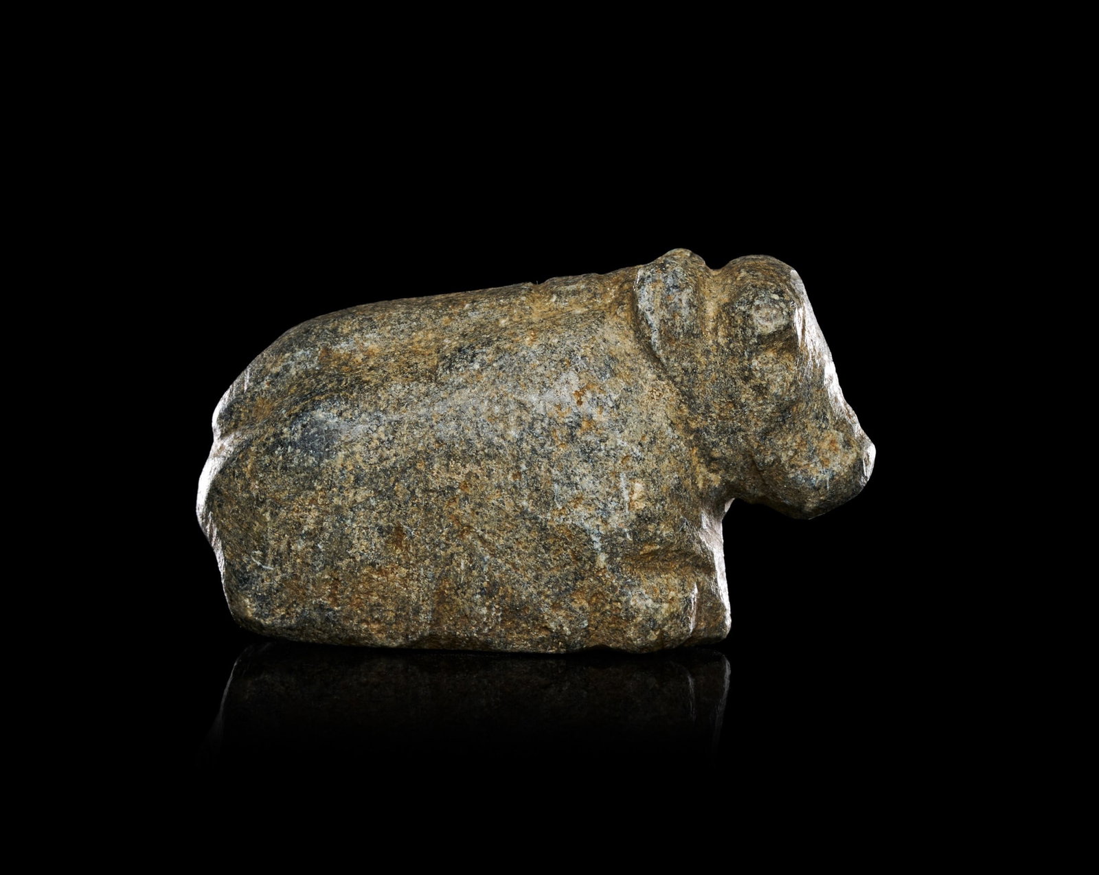 A MESOPOTAMIAN STEATITE BULL EARLY DYNASTIC III, CIRCA 2500 B.C.: A MESOPOTAMIAN STEATITE BULL, EARLY DYNASTIC III, CIRCA 2500 B.C.Carved in the round from a mottled grey-green steatite, the recumbent bull is rendered as a compact, block-like mass with legs folded b