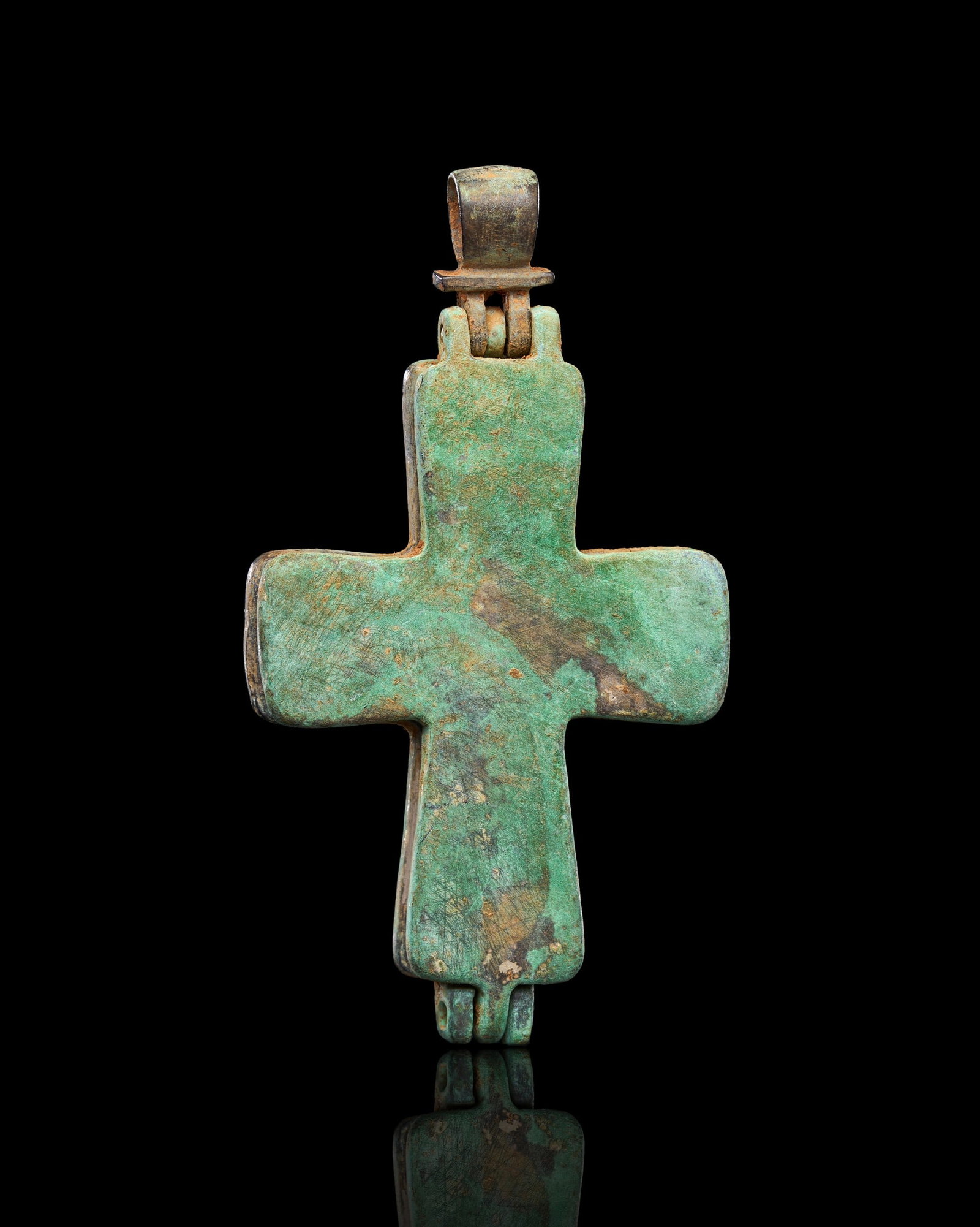 A BRONZE PENDANT CROSS BYZANTINE, 5TH-7TH CENTURY: A BYZANTINE BRONZE RELIQUARY CROSS PENDANT (ENKOLPION), EASTERN MEDITERRANEAN, 5TH-7TH CENTURYOf Latin form with slightly flaring arms of rectangular section, the cross cast in two hinged halves joine