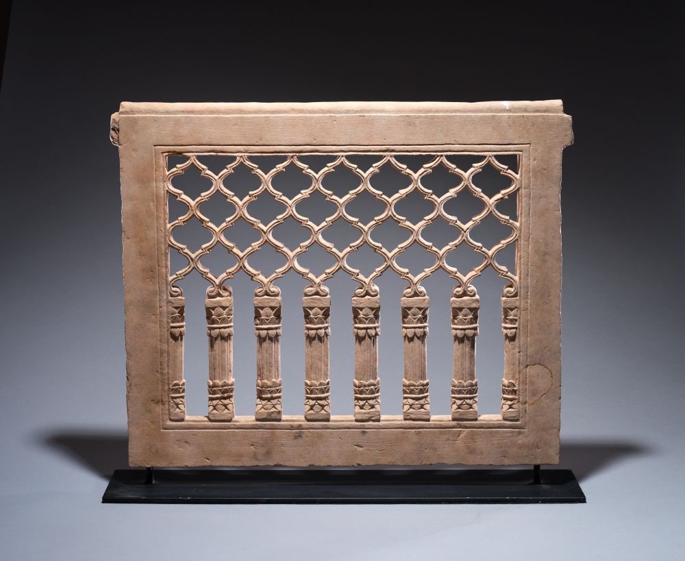 A MUGHAL RED SANDSTONE CHINIKANA PANEL, INDIA, 18TH CENTURY: A MUGHAL RED SANDSTONE CHINIKHANA PANEL, INDIA, 18TH CENTURY Of rectangular form, carved in openwork from a single slab of sandstone and surmounted by a projecting flat cornice. The lower register is 