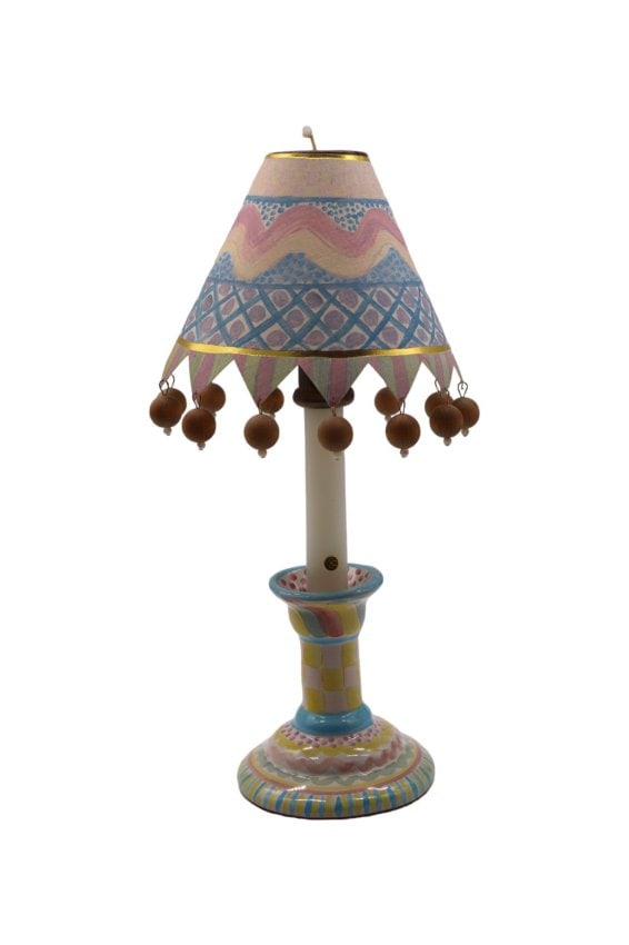 MacKenzie Childs “Aurora” Candleholder with Paper Shade and Brass Insert: Lovely MacKenzie Childs single candlestick holder in the Aurora pattern which has since been discontinued. The piece features blue and yellow striped edge and the paper shade has similar designs with
