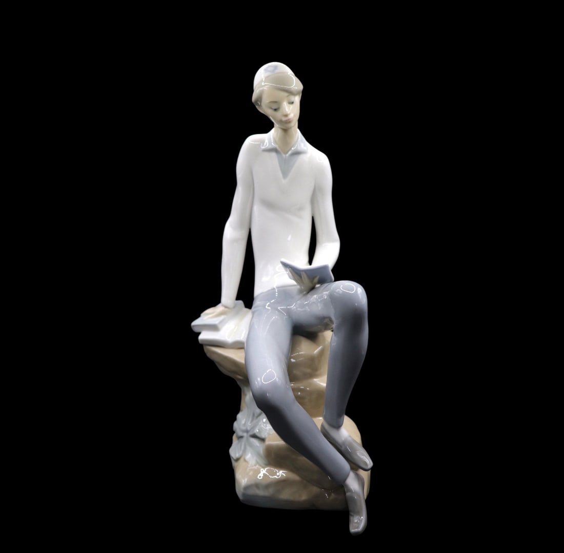 Lladró “Hebrew Student” Porcelain Figurine: Lovely Lladró porcelain figurine titled Hebrew Student in great vintage condition with no noticeable chips, deep scratches, cracks or repairs. It features a young man sitting down and reading the Tor