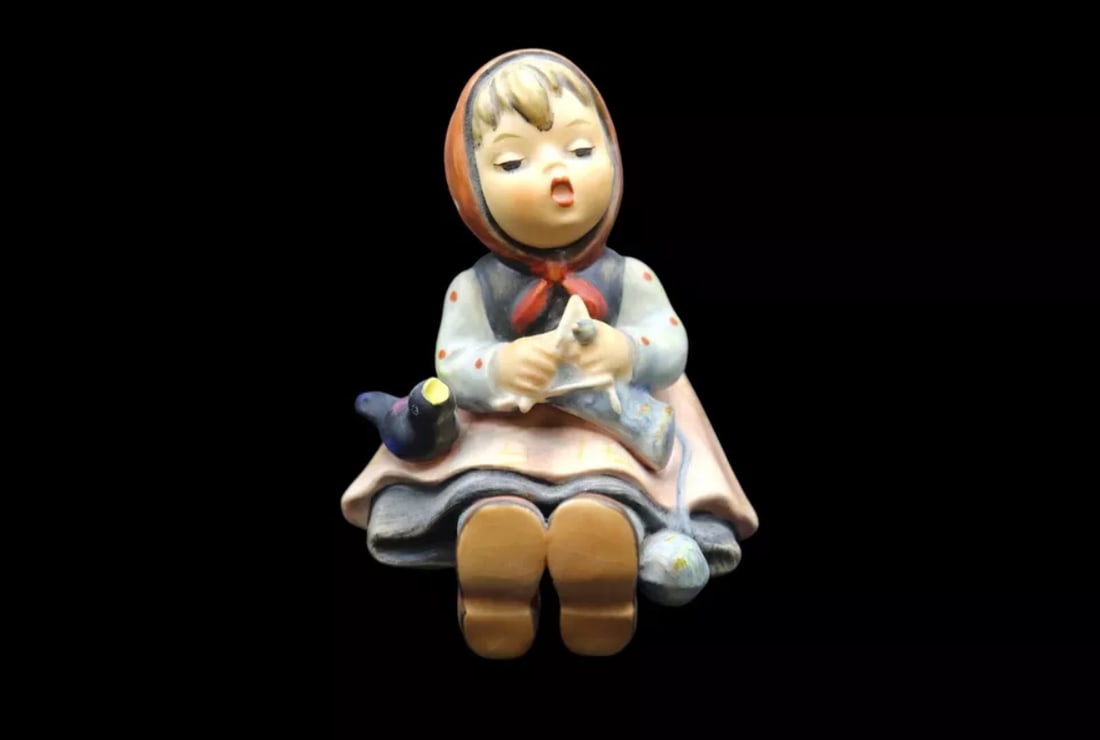 Goebel Hummel Porcelain “Happy Pastime” #69 Figurine - TMK3: Adorable Goebel Hummel porcelain figurine titled Happy Pastime in good vintage condition with no chips, scratches or cracks but it does show some crazing. It features a young girl sitting down enjoyin