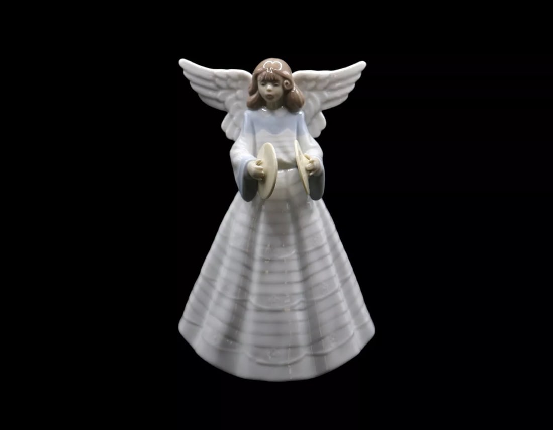Lladró “Angelic Cymbalist” Porcelain Figurine with Original Box: Lladró porcelain figurine titled Angelic Cymbalist which was released in 1993 and discontinued in 1993. The piece was designed by Francisco Catala and is in excellent condition with no noticeable dam