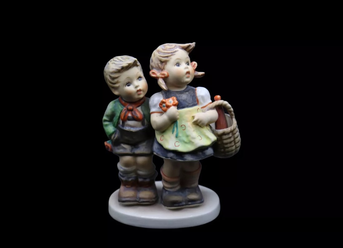 Goebel Hummel Porcelain “To Market” #49/0 Figurine - TMK6: Goebel Hummel porcelain figurine titled To Market in good vintage condition with no chips, scratches or cracks. The piece shows considerable crazing throughout. It features two siblings headed to the