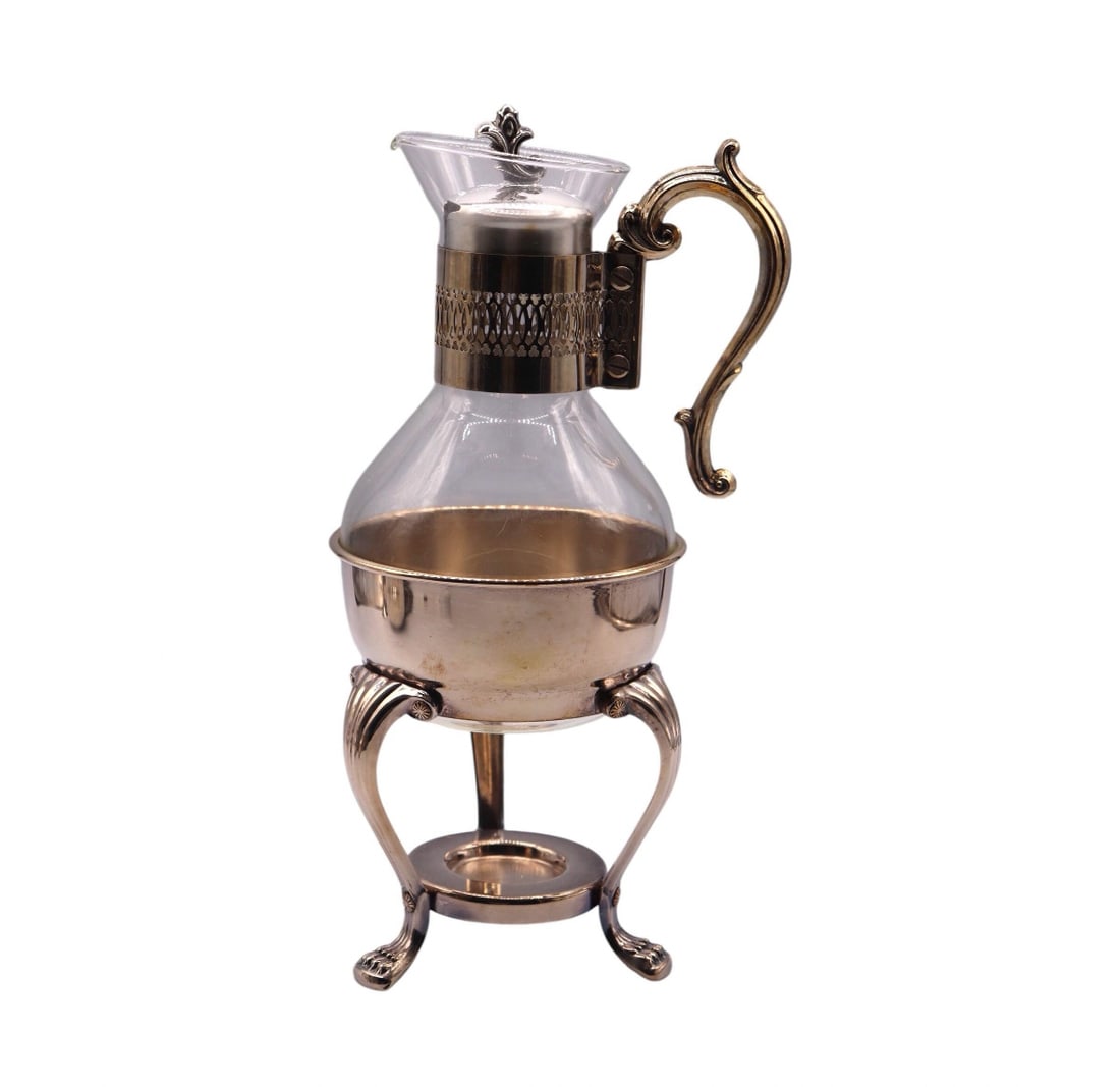 F.B Rogers “Provincetown” Silverplate & Glass Coffee Carafe w/ Silverplate Stand: F.B. Rogers “Provincetown” Silverplate & Glass Coffee Carafe with Silverplate Stand is a timeless piece perfect for collectors or anyone who appreciates vintage serveware. The carafe stands ap
